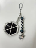 Phone charm with geometric design and EXO logo on a white background